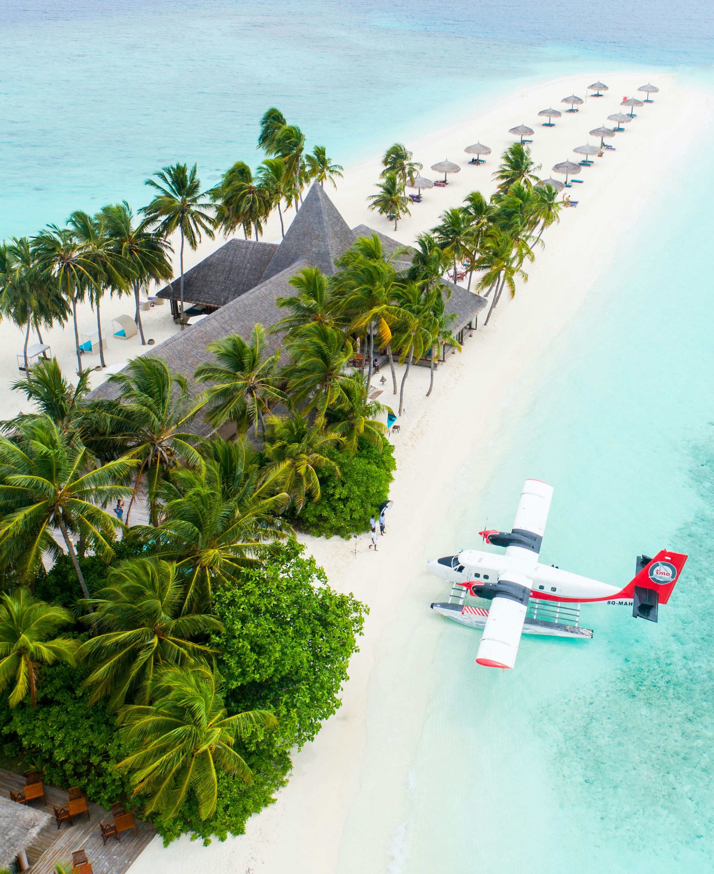 Tropical island, white-sand beach and seaplane